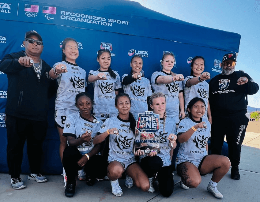 Apex Predators posing with their championship rings won at a youth tournament.