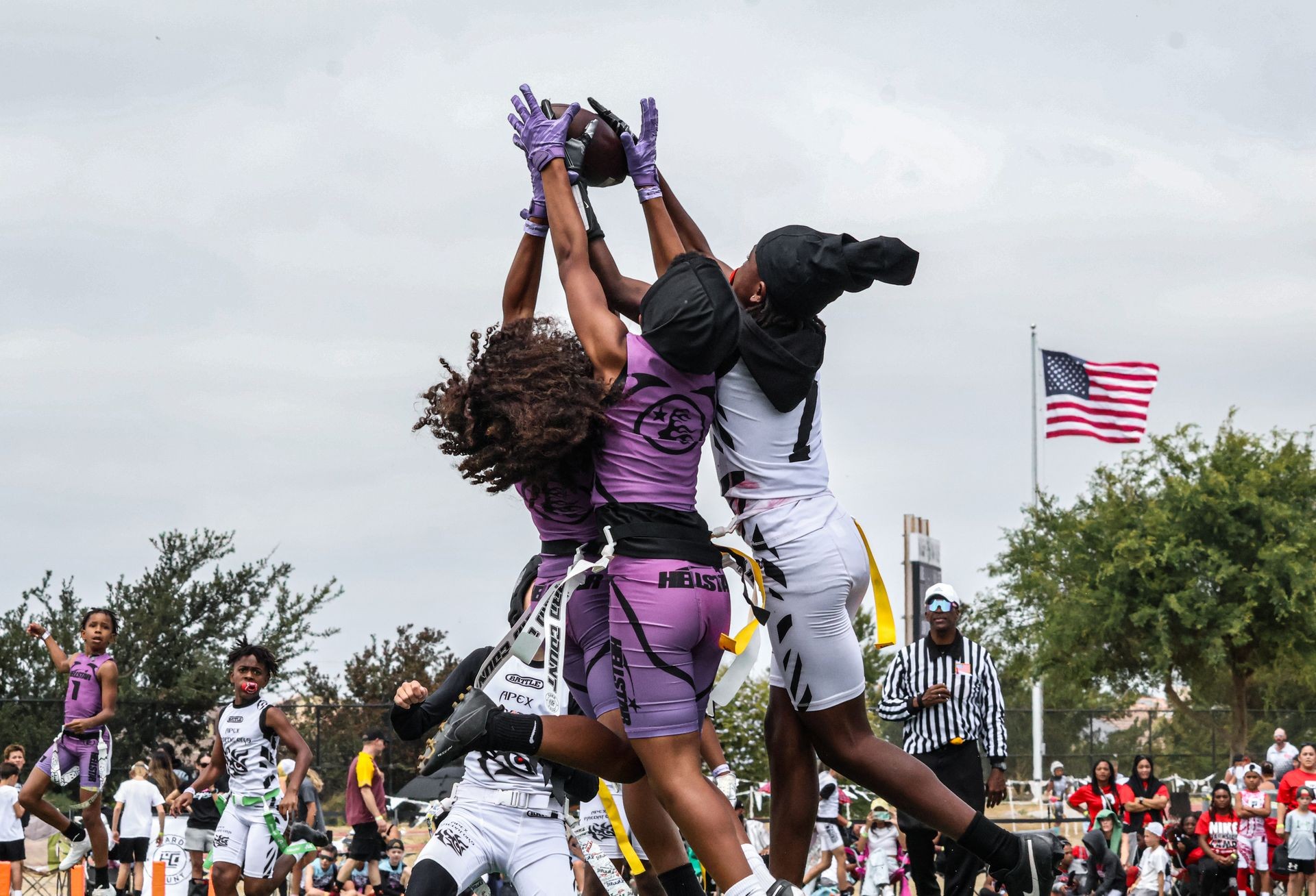 An Apex Predator leaping to intercept a pass in flag football tournament action.